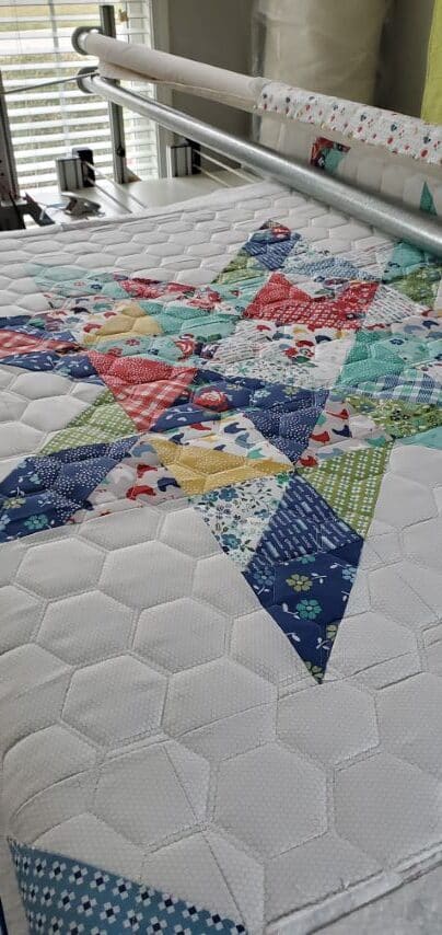 Charming Sawtooth baby quilt in bright farm print fabric