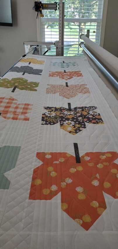 Fall Leaves quilt blocks on a longarm